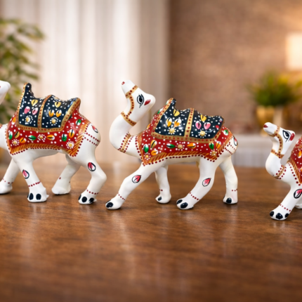 Handcrafted camels with ornate saddles