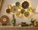 Rajasthani handcrafted home decor setup with decorative wall art, marble clock, painted vase and elegant living room styling.