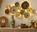 Rajasthani handcrafted home decor setup with decorative wall art, marble clock, painted vase and elegant living room styling.